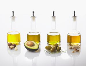 Four bottles of different types of oils in a row