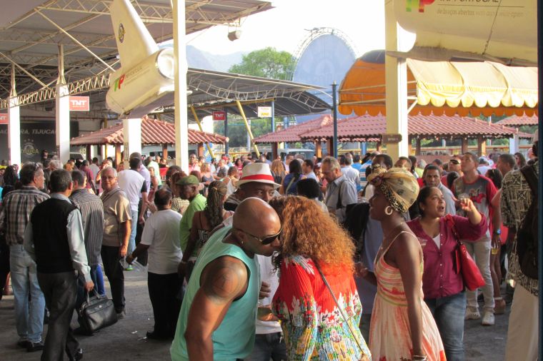 Young black men talk to Brazilian women at a May 13 celebration.