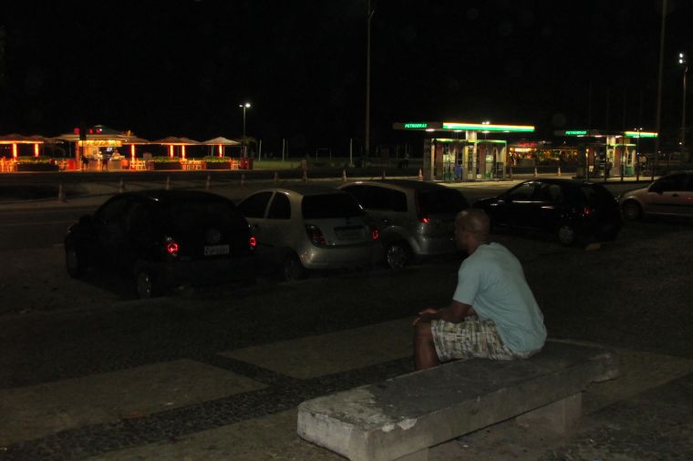 Casey Frost on a bench across the street from Copacabana Beach
