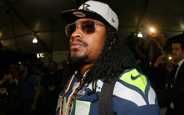 Running back Marshawn Lynch #24 of the Seattle Seahawks leaves his podium during a Super Bowl XLIX media availability at the Arizona Grand Hotel on January 28, 2015 in Chandler, Ariz. (By Christian Petersen/Getty Images)