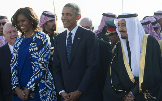 Saudi new King Salman walks alongside President Barack Obama and first lady Michelle Obama after the Obamas arrived on Air Force One at King Khalid International Airport in Riyadh on January 27, 2015. Obama landed in Saudi Arabia to shore up ties with new King Salman and offer condolences after the death of his predecessor Abdullah. (SAUL LOEB/AFP/Getty Images)
