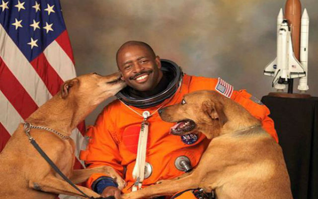 Retired NASA astronaut Leland Melvin and his dogs, Jake and Scout, in his official portrait. (Twitter)