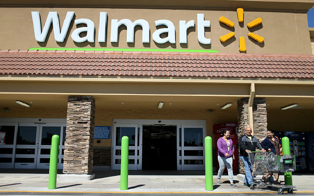 Walmart customers exit from the store on February 19, 2015 in Miami, Fla. The Walmart company announced Thursday that it will raise the wages of its store employees to $10 per hour by next February, bringing pay hikes to an estimated 500,000 workers. (Photo by Joe Raedle/Getty Images)