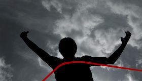 Black man frolicking Silhouette of athlete at finish line
