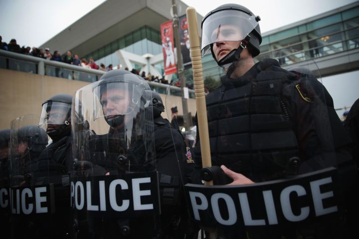 Police in riot gear confront protesters