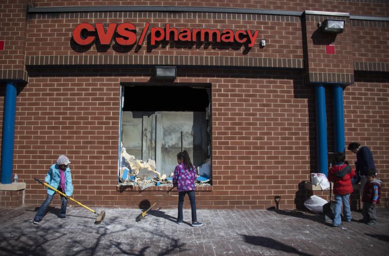 Volunteers clean up the looted CVS in Baltimore.