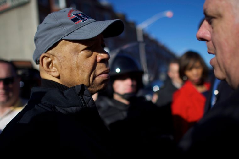Congressman Elijah Cummings listens to people on the street Tuesday morning in Baltimore.