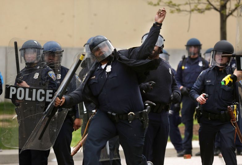 Baltimore police throw rocks