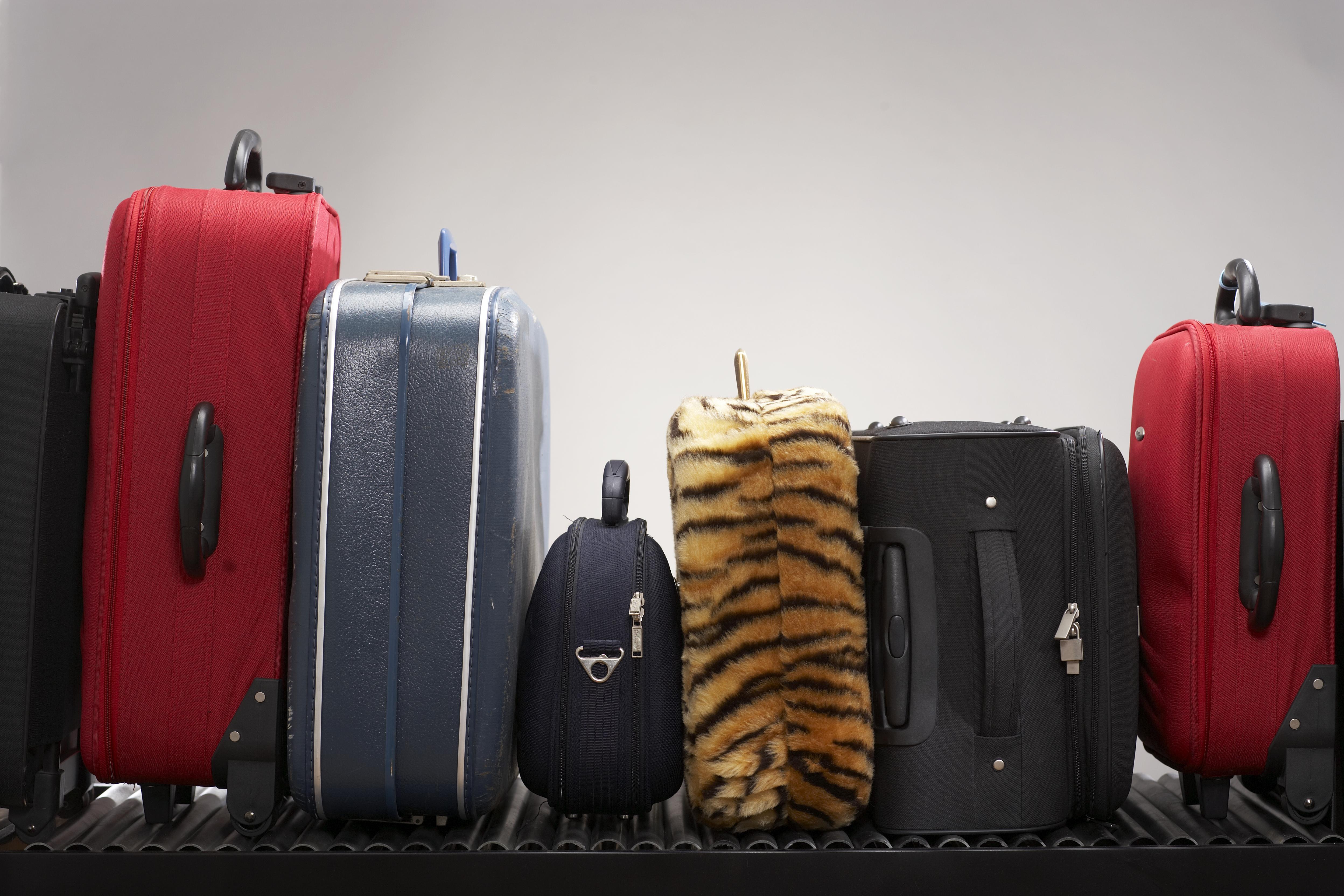 Various suitcases on conveyor belt