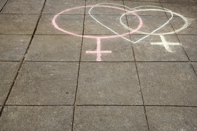 High angle view of two female symbols drawn on the road with a heart shape