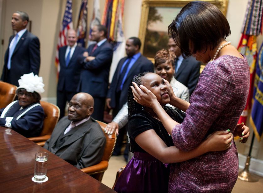 Michelle Obama with a small group of African American seniors and their grandchildren in the Roosevelt Room of the White House