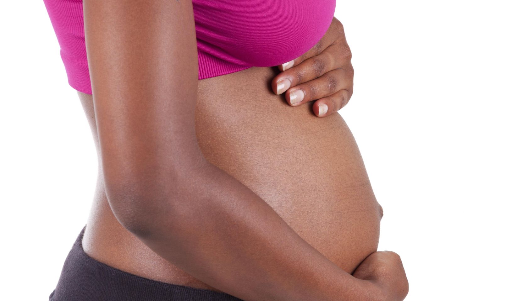 Young pregnant black woman touching her belly, isolated on white background - African people