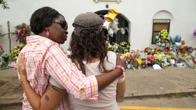 Charleston natives comfort each other during the church’s first service since the shooting on June 17.