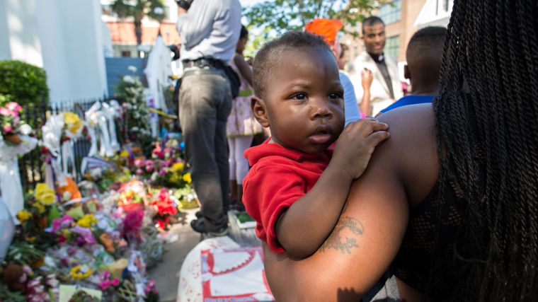 A mother and son surround a memorial for the nine church members killed during the Charleston shooting.