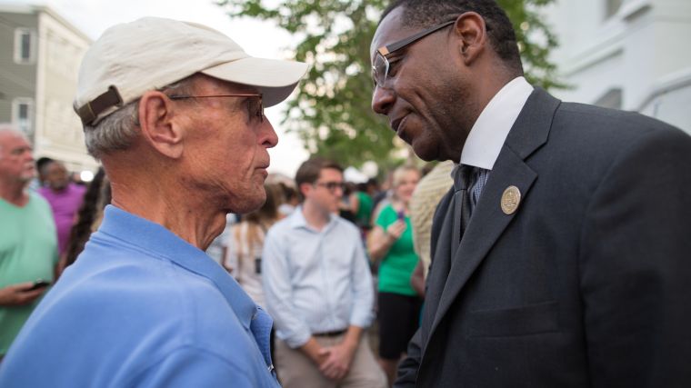 Church members comfort one another outside of Emanuel.
