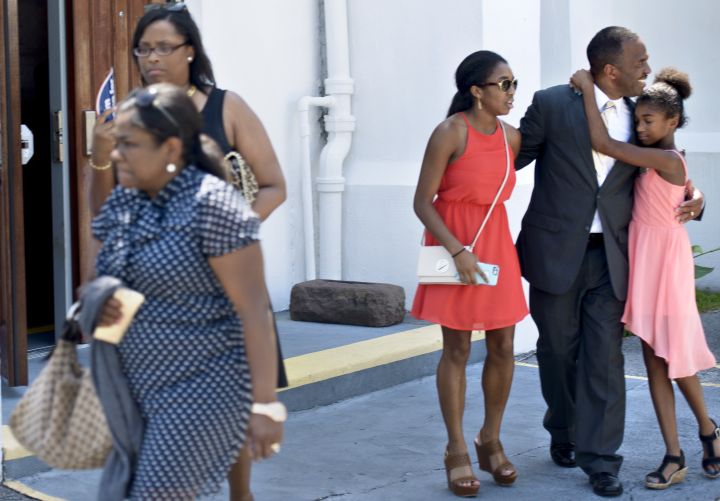 A family is seen leaving Emanuel AME Church following Sunday services.