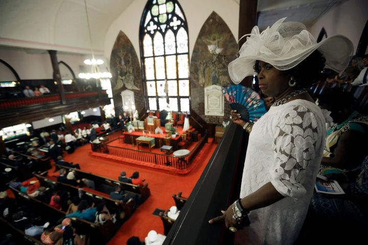 Gloria Moore watches the church as parishioners take their seats at the Emanuel AME Church.