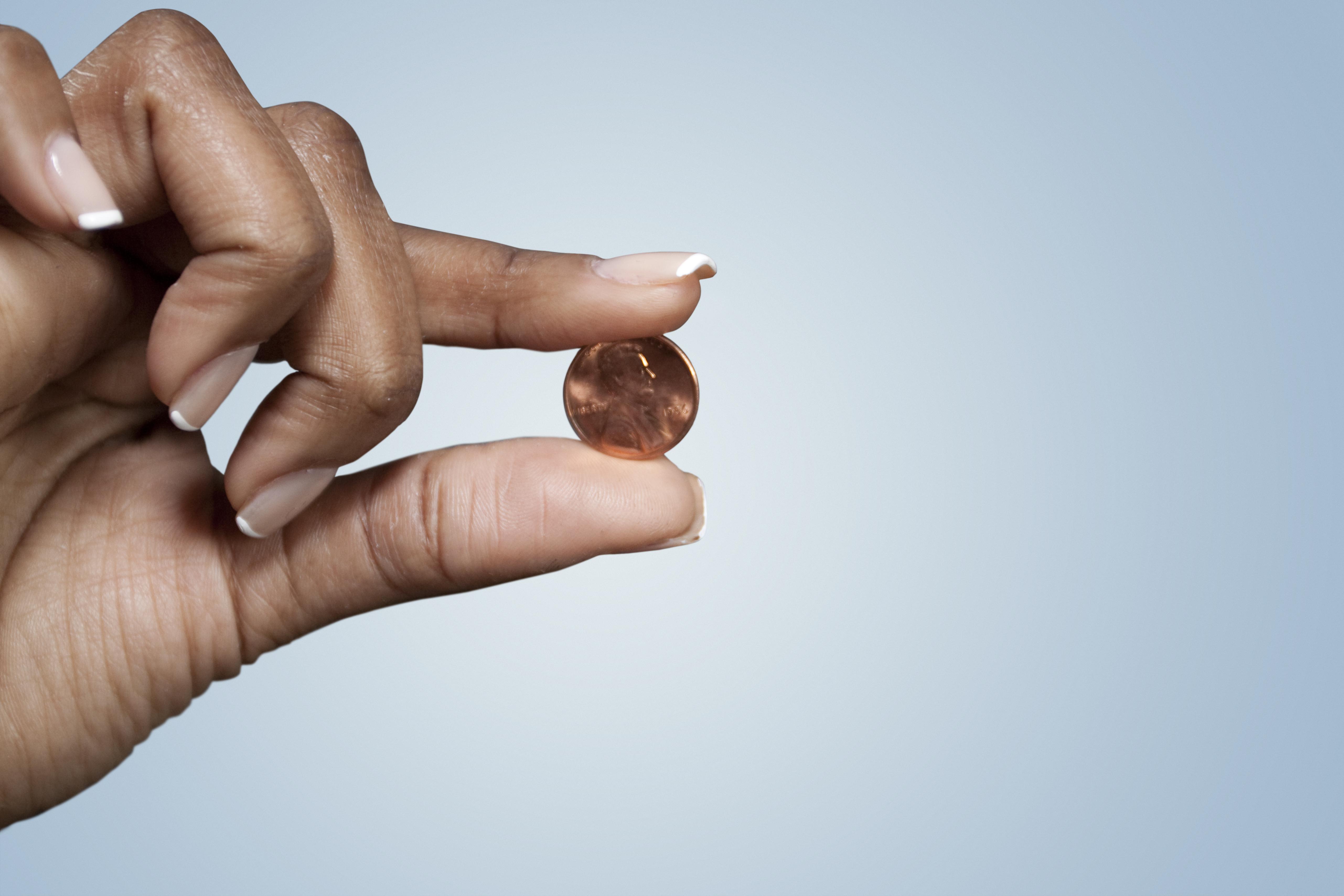 Black woman's hand holing penny