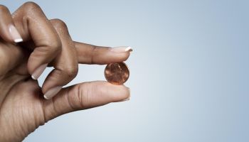 Black woman's hand holing penny