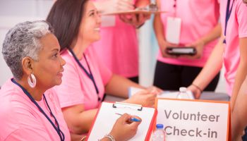 Breast Cancer Awareness volunteers sign up for local event.