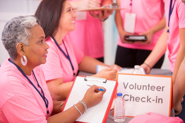 Breast Cancer Awareness volunteers sign up for local event.