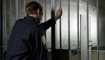 A prison guard locking a prison door