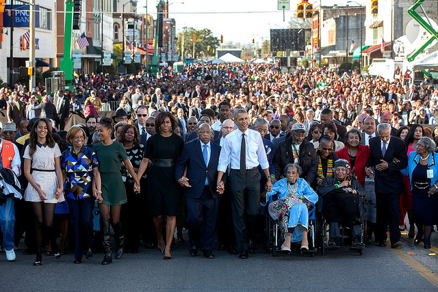 MARCH: President Barack Obama and First Lady Michelle Obama join hands with Rep. John Lewis, D-Ga. as they lead the walk across the Edmund Pettus Bridge to commemorate the 50th Anniversary of Bloody Sunday and the Selma to Montgomery civil rights marches, in Selma, Ala., March 7, 2015. Malia and Sasha Obama join hands with their grandmother, Marian Robinson.