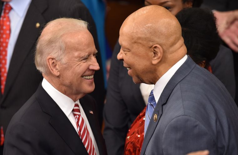 Biden greets civil rights leader and US representative John Lewis as they wait for the president.