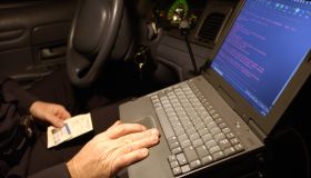 Police officer using computer in car