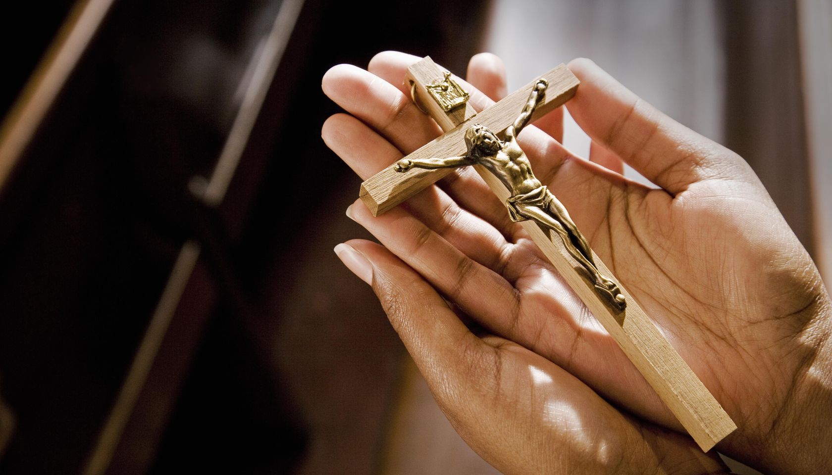 Hands in Church Holding Crucifix