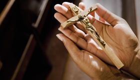 Hands in Church Holding Crucifix