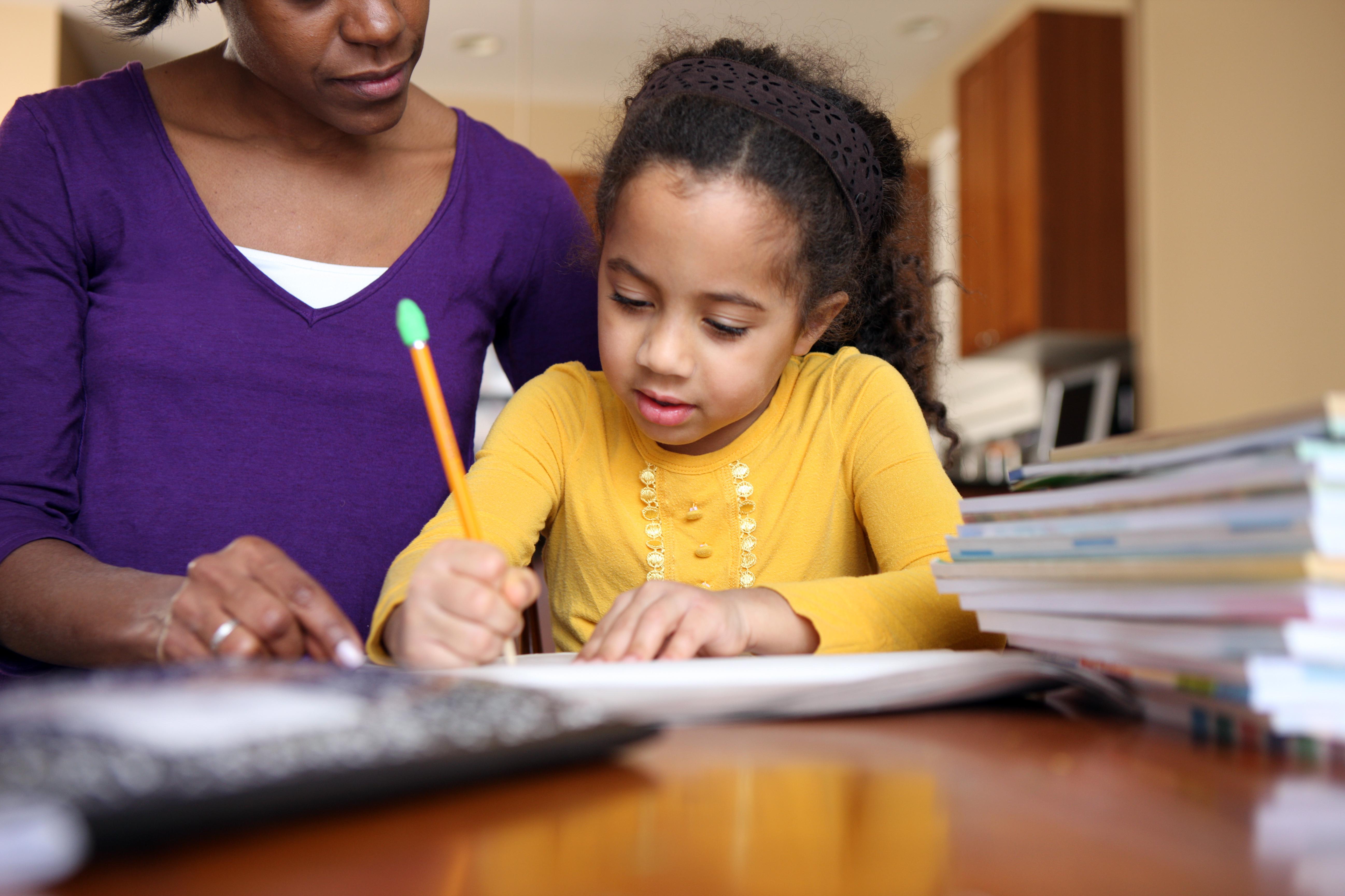 Mom helping daughter with school work.