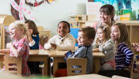 Teacher with group of preschoolers sitting at table