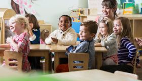Teacher with group of preschoolers sitting at table