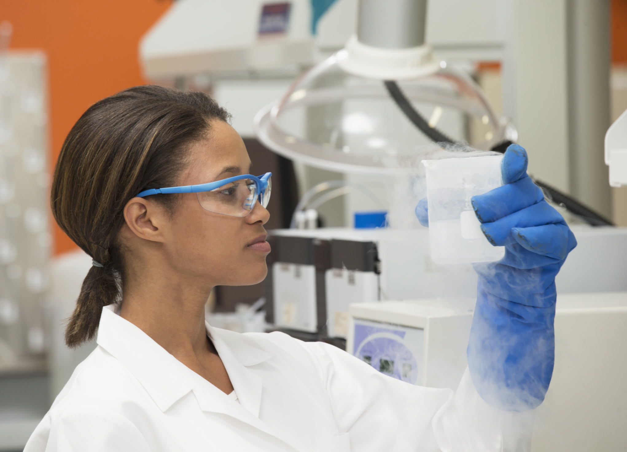 Black scientist examining liquid in laboratory