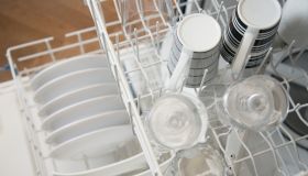 View from above of clean dishes in dishwasher.