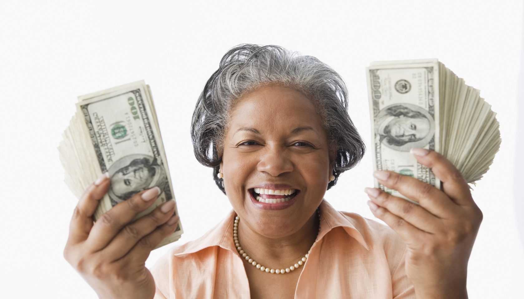 Portrait of senior African woman holding money