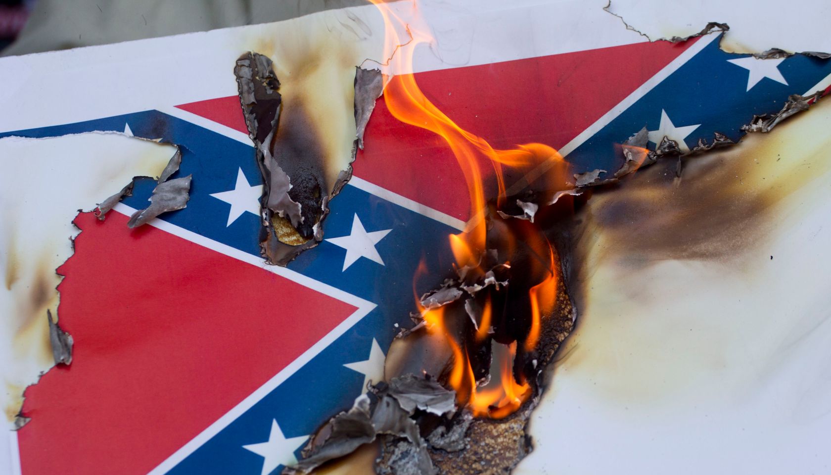 Activists In Los Angeles Gather To Burn Likenesses Of The Confederate Flag