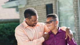 Proud African American father with teenage son