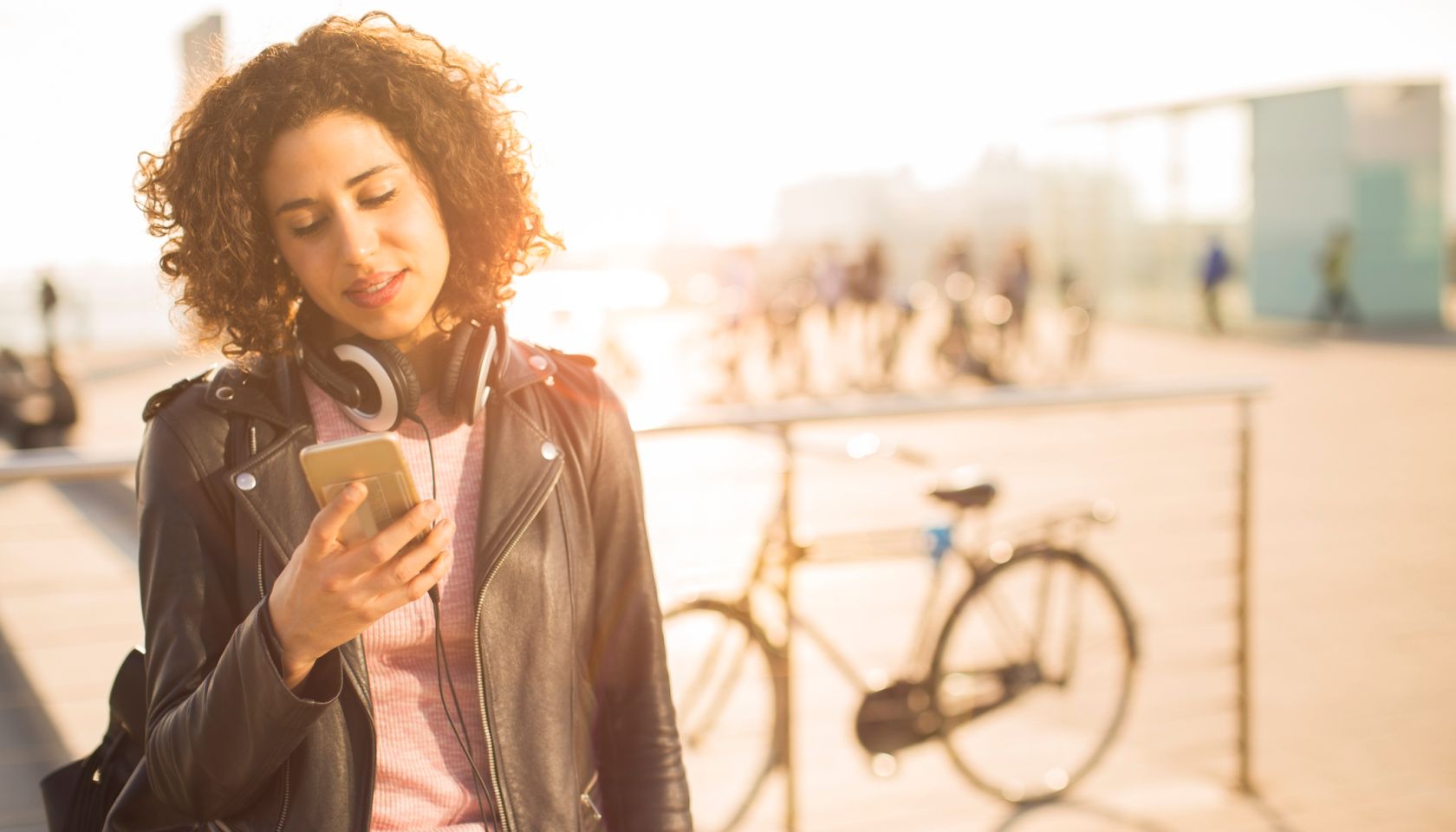 Beautiful young woman texting on her smart phone.