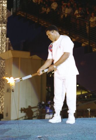 19 Jul 1996: Muhammad Ali holds the torch before lighting the Olympic Flame during the Opening Cere