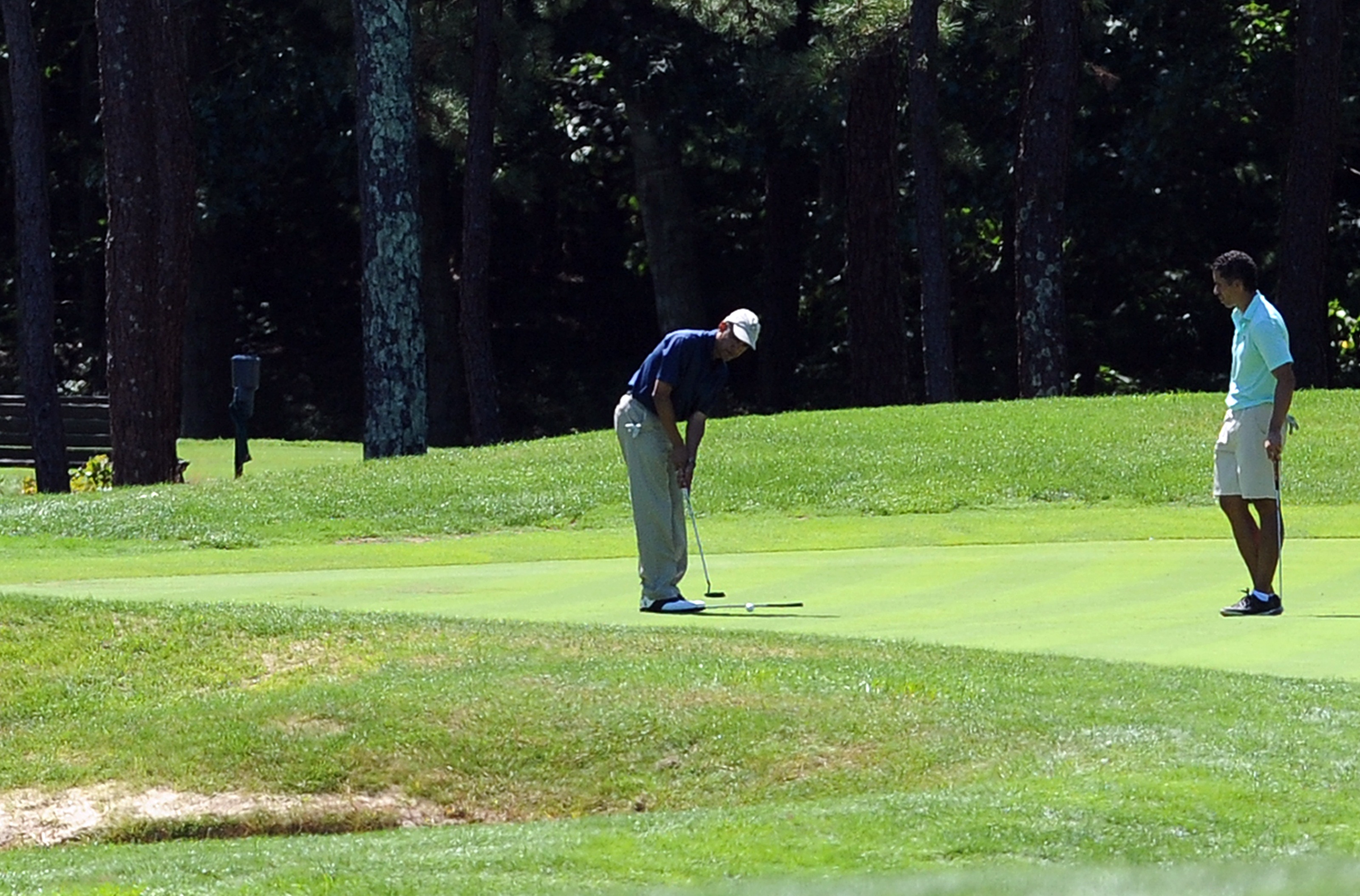 US President Barack Obama putts on the f