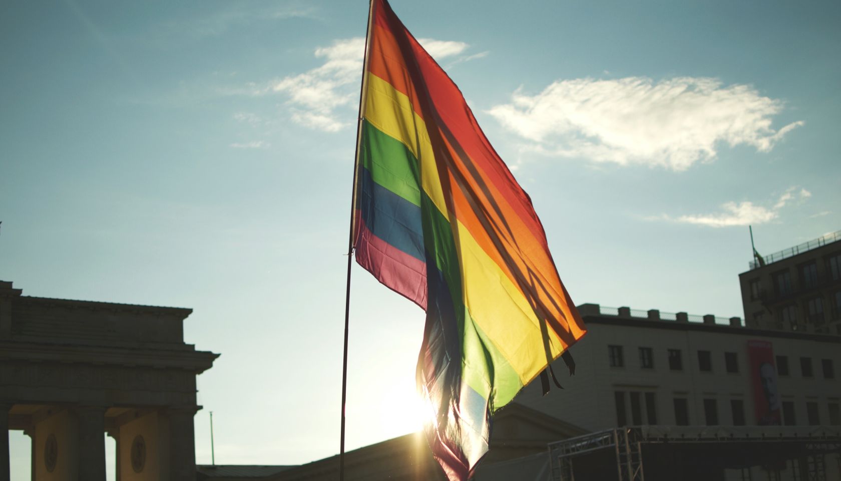 Low Angle View Of Rainbow Flag At Brandenburg Gate Against Sky