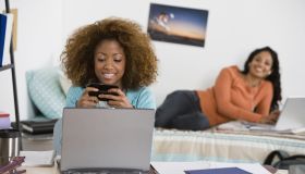 Women using laptops and cell phone