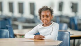 Young Student Sitting at Her Desk