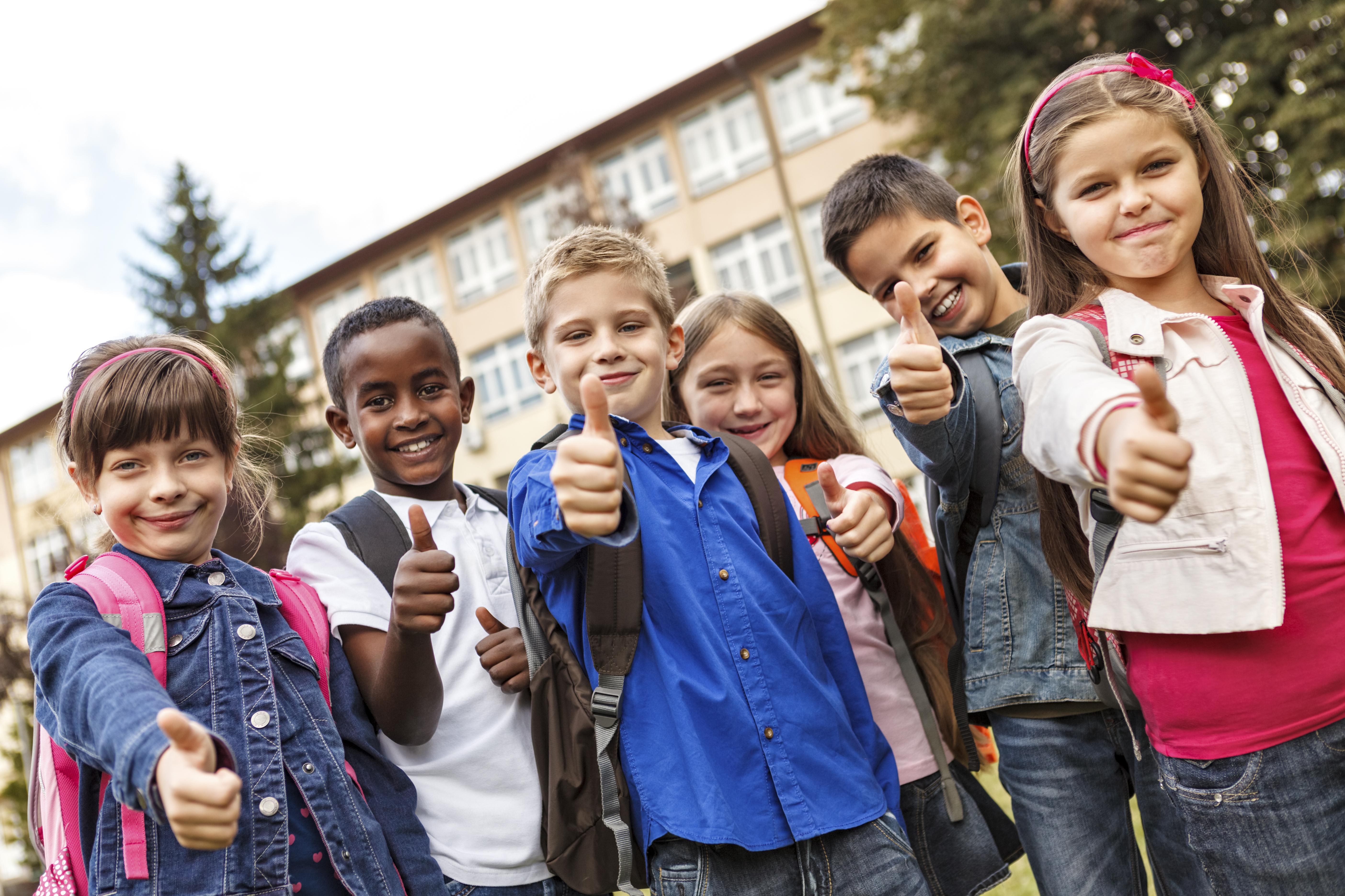 Group of multiracial school children showing thumbs-up