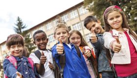 Group of multiracial school children showing thumbs-up