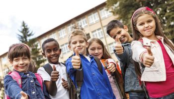 Group of multiracial school children showing thumbs-up