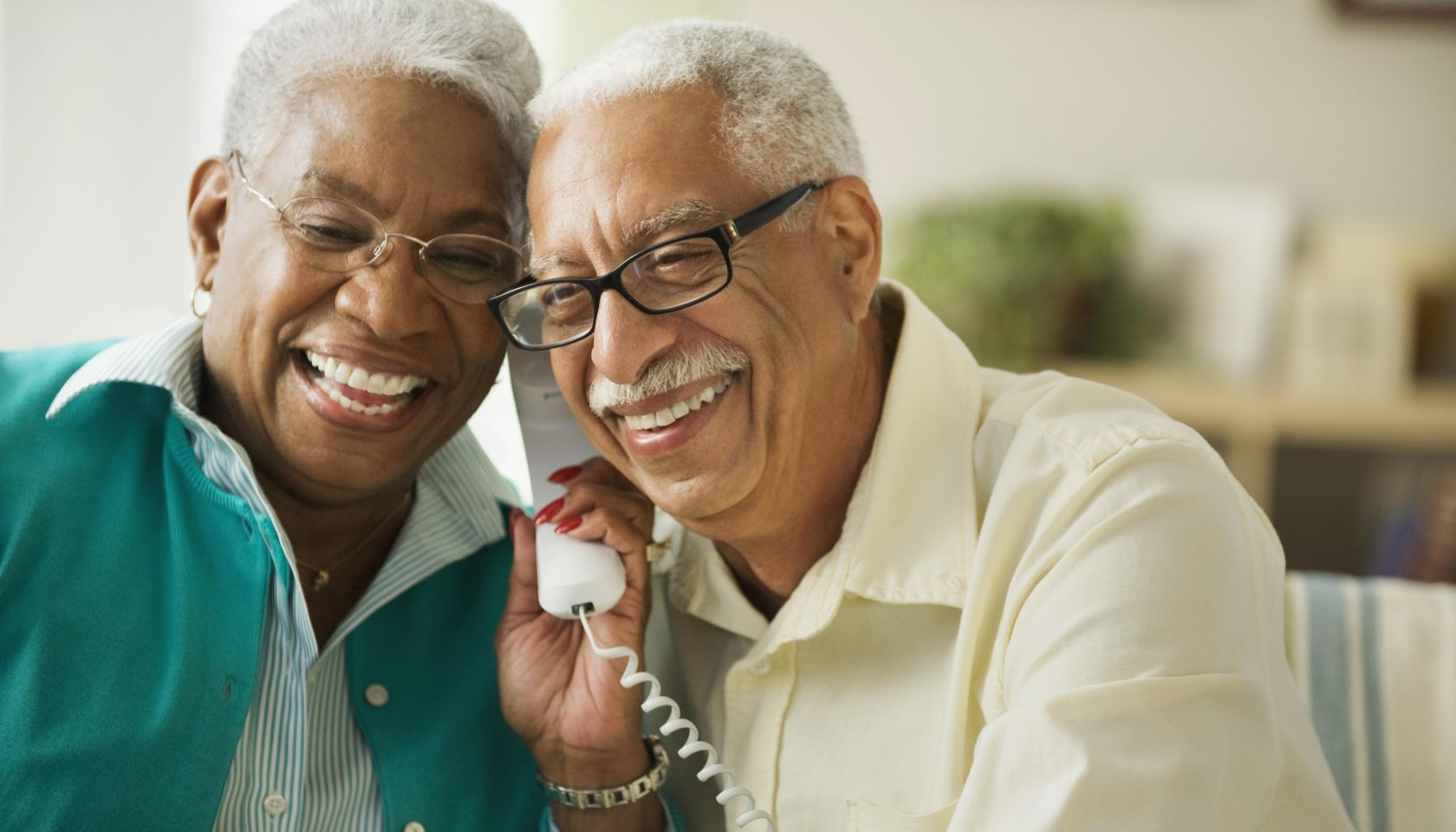 Elderly couple talking on the phone