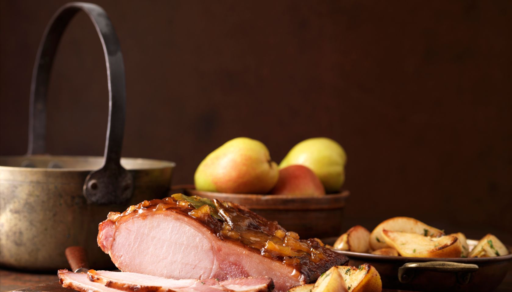 Christmas dinner. Roasted pear and muscavado sugar cured loin with potatoes, apples and herbs